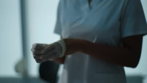 Closeup Unrecognizable AfricanAmerican Female Nurse Hands Takes Off Gloves After Successful Surgical