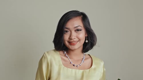Smiling Woman Poses with Modern Haircut and Jewelry