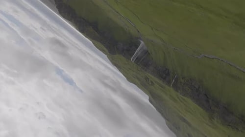 Aerial View of Waterfall and Green Hills