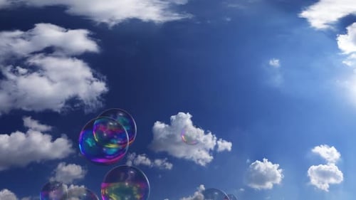 Shiny Bubbles Rising Against Clear Blue Sky