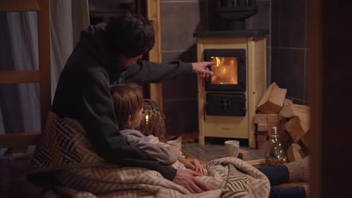 Father and Child Cozy by Wood Burning Stove