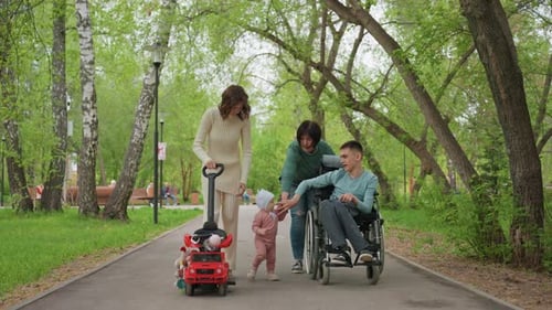 Family Enjoying Outdoors People Walking Through Shaded Trail Adult Women With Child On Scenic Route