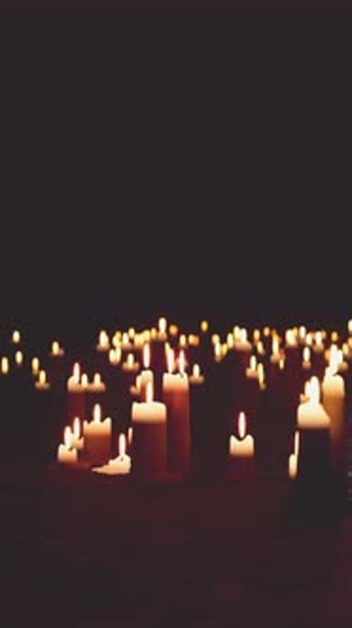 Multiple Lit Candles Illuminating the Darkness