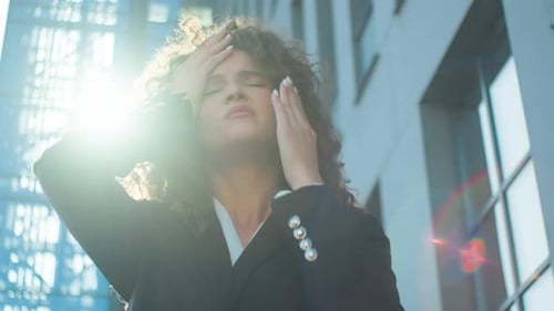Stressed Woman Holding Head Outdoors Downtown