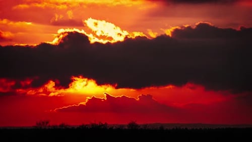Brilliant Orange Sunset with Moving Clouds Time Lapse