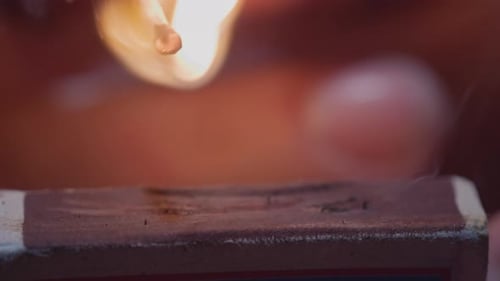Lighting a Match on a Matchbox in Close Up