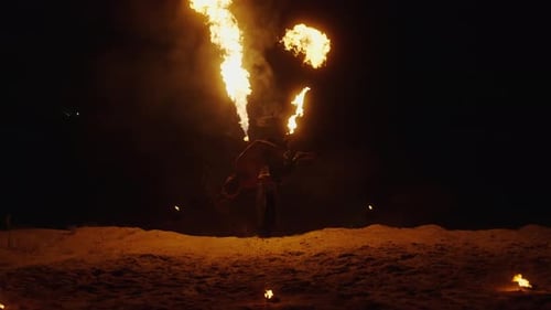 Dynamic Fire Performer at Night with Flames