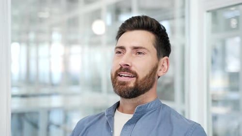 Close up of a handsome businessman relaxing with his eyes closed sitting in the office. Calm happy