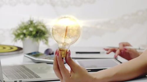 A businesswoman has an idea - Concept: lightbulb, bright, idea, solution, creative, business, global