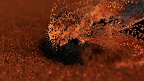 Black Particles Flow Upward Through Vibrant Orange Particles Against a Striking Black Background