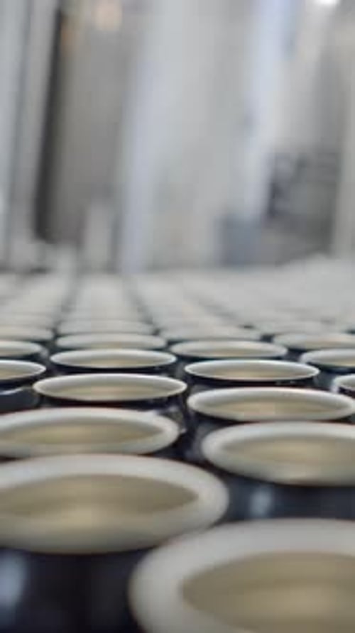 Empty Beer Cans On The Conveyor In The Factory Rack Focus