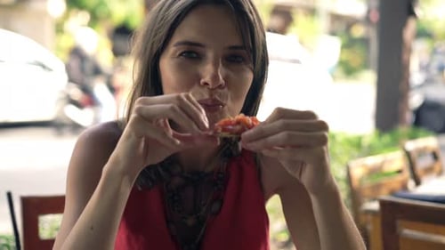 Young Woman Eating Vegetables Sitting in Cafe in City 30s