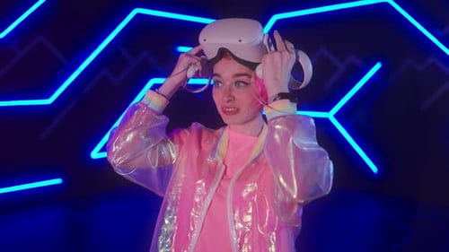 Woman Enjoys Virtual Reality Experience with Neon Lighting