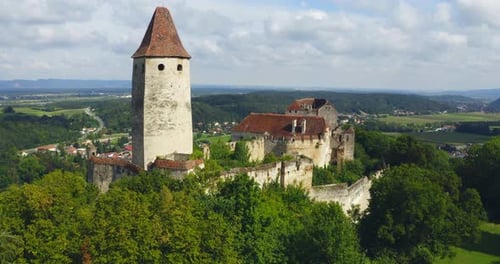 Aerial view of a castle on top of the mountain.