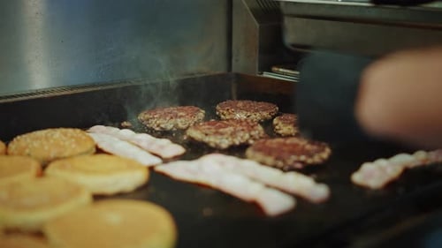 Tasty Close Up Footage of a Meat Patties Prepared on a Griller. Fresh Ground Beef is Grilled on a H
