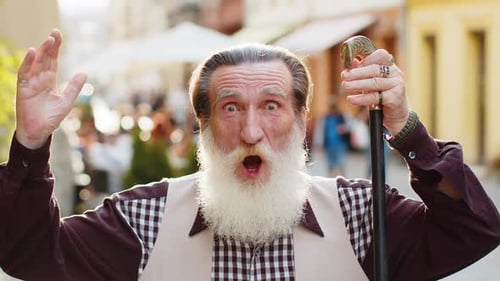Senior Man Looking Surprised at Camera Shocked By Sudden Win Good Victory News Wow in City Street