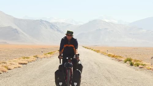Caucasian Cyclist Cycle Pamir Highway (Front View)