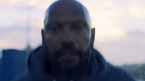 Sweaty Man Wearing Hoodie Breathing Heavily at Sunset