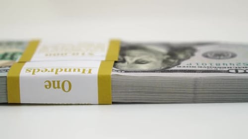 Stack of Bank Bundles with US Dollars on a White Background Closeup Shot of New Freshly Printed