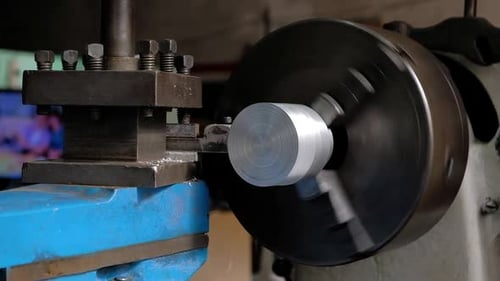 Metal Lathe Shaves Cylindrical Piece in Close-Up