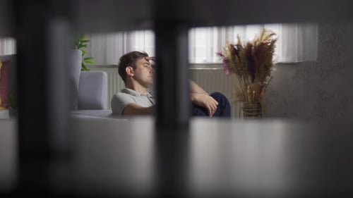 Angry man putting hands on head feeling depressed at home.
