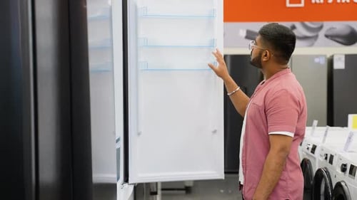 Indian Man is Viewing Fridge in Home Appliances Store