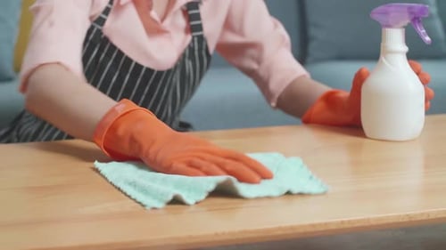 Close Up Of Female Housekeeper's Hands Cleaning The Table By The Spray At Home