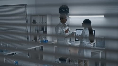 Scientists Discuss Research in Modern Laboratory Setting