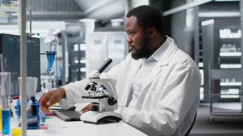 Scientist Using Microscope in Modern Research Laboratory
