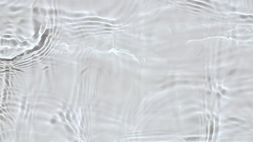 Pure Beige Water with Reflections Sunlight in Slow Motion Water Surface Texture Top View Sun and