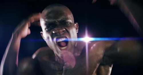 An athletic young man against a black background