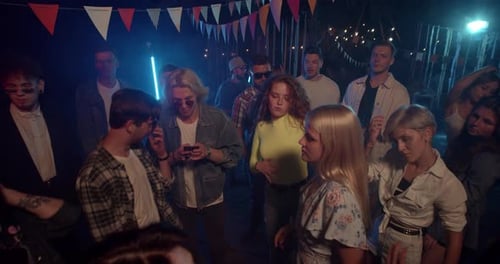 Young Adults Dancing at an Outdoor Night Party