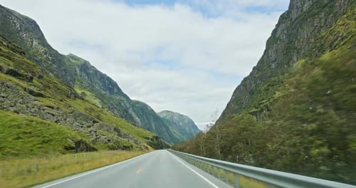 Driving on Scenic Norwegian Road Through Mountain Valley