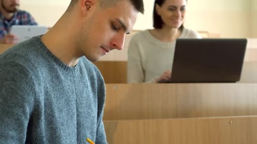 Focused Student Studying in a Classroom at College