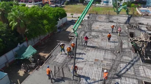 Aerial View Builders Preparing Rebar and Floor for Upcoming Work on a New Construction Site