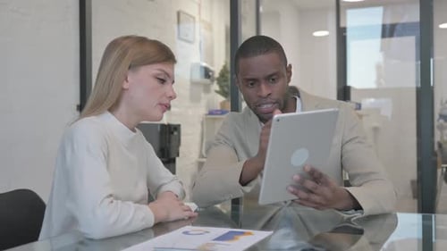 Business People Working on Tablet in Office