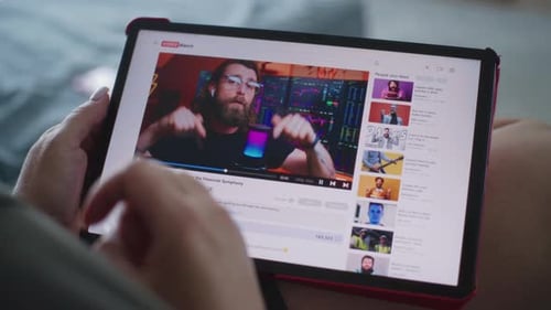 Video Hosting Website Interface with Video About Trading Displayed on Tablet Screen