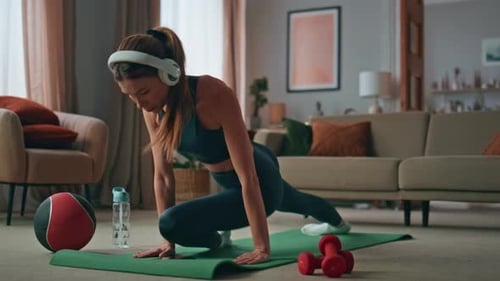 Athletic Woman Stretching on Mat at Home