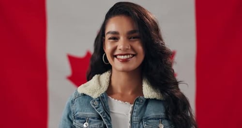 Woman Smiling in Front of Canadian Flag