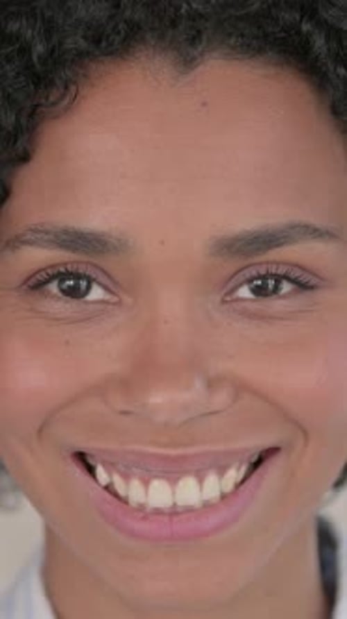 Close up of Beautiful African Woman Smiling at Camera, vertical video