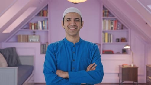 Smiling Man in Taqiyah Poses Indoors