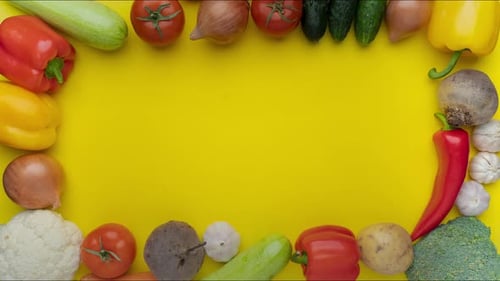 Moving Vegetables on Yellow Background