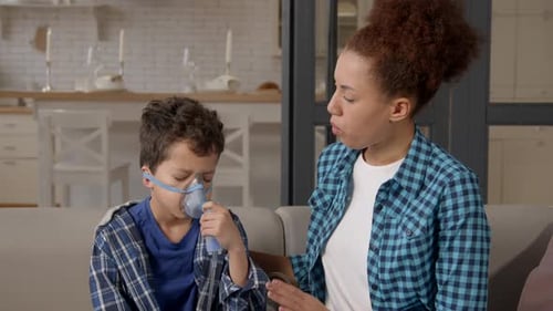 Woman and Boy with Oxygen Mask