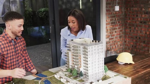 Architects Discussing Building Model in an Office Setting