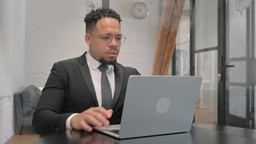 Tired Multiracial Businessman Leaving Workspace, Closing Laptop