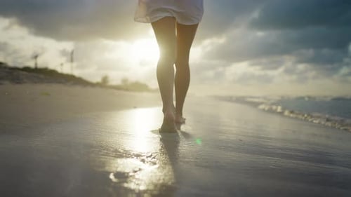 Relax on Seashore in Summer Woman Strolling on Sand Back View of Slender Legs Warm Water Washing