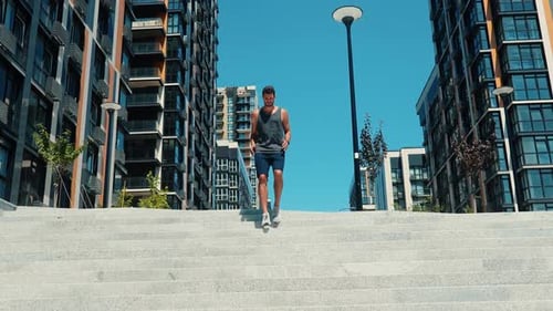 Man Running Up Staircase in Urban Setting