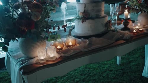 Romantic Dessert Table With Wedding Cake at Night