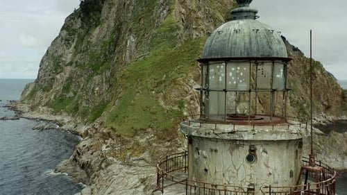Old Lighthouse and Rocky Coastline View