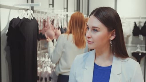 Woman Glances at Shoppers in Lingerie Store